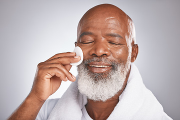 Image showing Black man, face and skincare with cotton for self care with dermatology and cosmetics for detox, glow and clean skin. Headshot of African male on studio background for facial beauty spa treatment