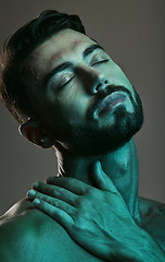 Image showing Man, face and neon with beauty and skincare, grooming and wellness with eyes closed against studio background. Healthy skin, relax in blue light and peace, male and cosmetic facial and treatment