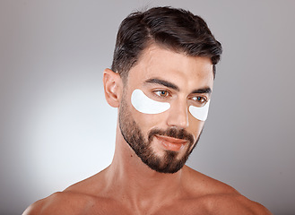 Image showing Skincare, beauty and man with mask for eyes on gray background for wellness, facial treatment and dermatology. Grooming, luxury spa and male with face patch, eye pads and cosmetics products in studio