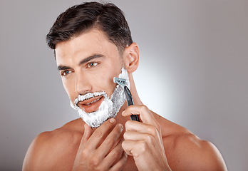 Image showing Grooming, foam and shaving with face of man with razor for beauty, hygiene and skincare with morning routine. Self care, facial and shave beard with model and cream product for wellness and cleaning