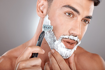 Image showing Grooming, foam and shaving with face of man with razor for beauty, hygiene and skincare with morning routine. Self care, facial and shave beard with model and cream product for wellness and cleaning