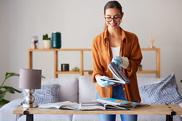 Image showing Cleaning, happy and woman with books in the living room, inspection and content with housework. Smile, check and cleaner spring cleaning a book for housekeeping and decluttering in lounge of a house