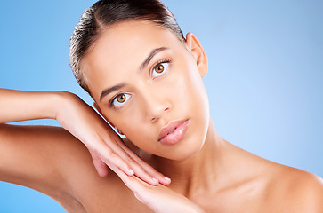 Image showing Portrait, skincare or model in studio after beauty or facial grooming routine on a blue background with mockup space. Luxury, healthy girl or beautiful woman touching face for self love or self care