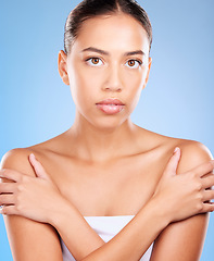 Image showing Skincare, beauty and portrait of a woman in a studio for natural, self care and body care treatment. Health, wellness and girl model from Brazil with a facial routine isolated by a blue background.