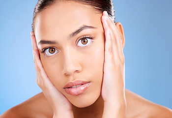 Image showing Portrait, skincare or model in studio after beauty or facial grooming routine on a blue background with mockup space. Luxury, healthy girl or beautiful woman touching face for self love or self care