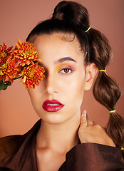 Image showing Makeup, beauty or woman in studio with flowers for art fashion and natural facial cosmetics for self care. Face portrait, orange plants or girl model with red lipstick, eyeshadow and glowing skin