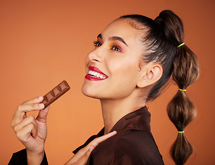 Image showing Beauty, eating and profile woman with chocolate bar, junk food or dessert for sugar sweets, candy snack or cheat meal. Face makeup, skincare cosmetics and hungry hair model with brown cacao product