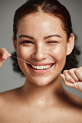 Image showing Teeth flossing, dental floss and portrait of woman with a smile in studio for oral hygiene, health and wellness. Face of happy female on grey for self care, healthcare and grooming for healthy mouth