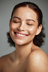 Image showing Face, beauty and skincare with a model black woman in studio on a gray background to promote natural care. Facial, wellness and makeup with an attractive young female happy with her skin product
