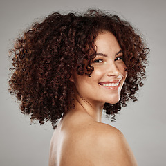 Image showing Portrait, face and skin with a model black woman in studio on a gray background for beauty treatment. Facial, wellness and natural with an attractive young female posing to promote a skincare product