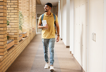 Image showing University student, college and indian man walking with a smile and backpack down campus corridor. Gen z male happy about education, learning and future after studying with scholarship at school