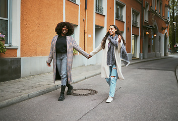 Image showing Love, holding hands and lesbian couple walking in street enjoying holiday, vacation and adventure. Fashion, lgbtq relationship and women together for happy interracial marriage, freedom and relaxing