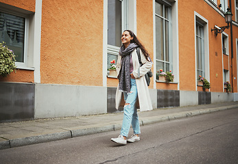 Image showing Happy, relax and woman in the city street for travel adventure, walking and thinking on a vacation in Italy. Peace, idea and traveler girl in a vintage road traveling a town during a holiday