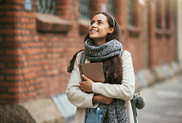 Image showing Travel, city and student walking with tablet on outdoor adventure in sidewalk street, road or journey In Chicago USA. Urban architecture buildings, opportunity or happy woman smile on winter vacation