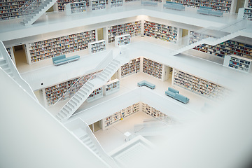 Image showing Library, research and education with books in an empty room with stairs to a floor on university or college campus. Learning, study and scholarship with book shelves in a school for development