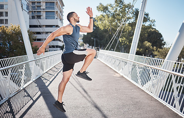 Image showing Fitness, running and exercise with a sports man on a bridge in the city for a cardio or endurance workout. Health, runner and training with a male athete exercising in an urban town for wellness