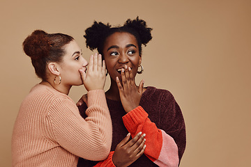 Image showing Friends, gossip and women share secret on studio background and product placement mockup. Secrets, rumor and surprise whisper in ear, black woman with happy woman discuss discount sale announcement