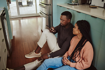 Image showing Black couple, phone and kitchen floor while online on internet together for social media or ecommerce. Young man and woman talking while at home to bond, relax and use wifi for communication app