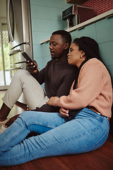 Image showing Black couple, phone and streaming with home wifi while online on internet together for social media or online shopping. Young man and woman talking while at home to relax and use communication app