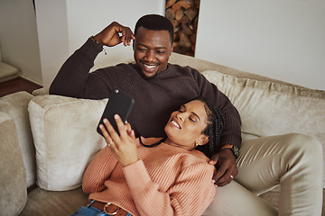 Image showing Black couple, phone and lounge couch while using home wifi for streaming internet or communication. Young man and woman talking while at home for social media app, online shopping and to relax