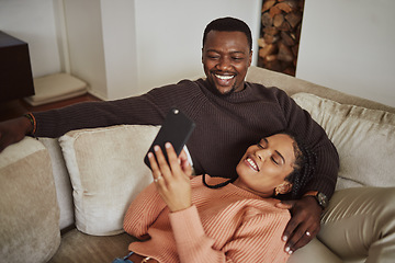 Image showing Black couple, phone and funny social media post while together on living room couch with home wifi for internet. Man and woman talking and laughing while streaming online, ecommerce or mobile app