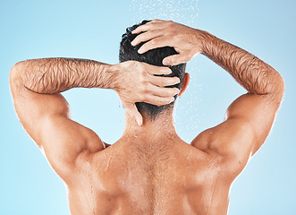 Image showing Water splash, man back and hair care shower for body hygiene, skincare grooming or cleaning care in blue background studio. Model, self care water cleansing and cosmetics wellness for morning routine