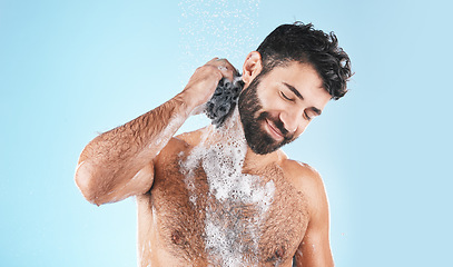 Image showing Shower, happy and man cleaning body with soap for health, fresh wellness and morning routine on a blue studio background. Skincare, water and model washing to clean skin for hygiene treatment