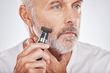 Image showing Senior man, shaving facial hair and grooming beard for skincare, hygiene and wellness with dermatolgy cosmetics. Hair removal, epilation and beauty of elderly male cleaning face on studio background