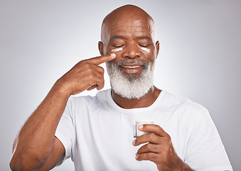 Image showing Beauty, facial cream and black man with dermatology or cosmetics for self care with skincare container. Face of happy African male with skin product on grey studio background for wellness and a glow