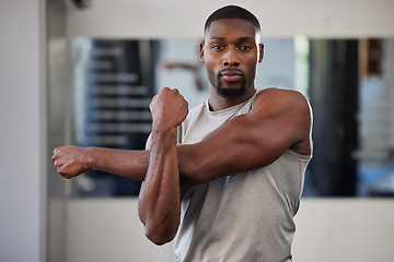 Image showing Gym portrait and black man stretching arms for bodybuilder fitness and muscle warm up with focus. Training, wellness and athlete man workout preparation for exercise lifestyle at health club.