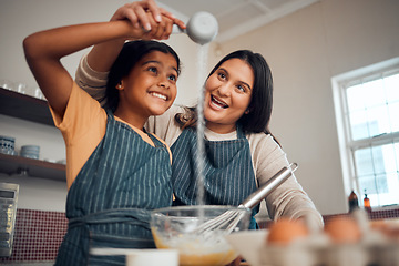 Image showing Baking, girl learning and mother with kitchen cooking, flour and home development of a kid and mom. House, parent care and child making cookies, cake or sweet food with a smile, love and happiness