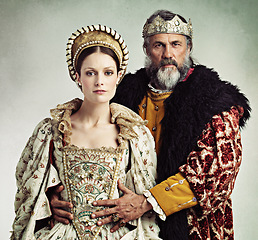 Image showing Crown, queen and king in costume isolated on studio background for medieval, renaissance and England culture. Headshot portrait of royal couple with power, wealth and vintage fashion for power