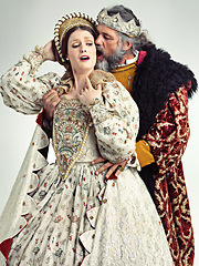 Image showing Medieval king, queen and violence in studio for drama, danger and together with renaissance clothes. Ancient royal couple, surprise and shock with distress, crying and actor with vintage fashion