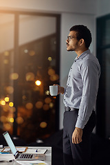 Image showing Coffee, night and businessman thinking of an email on a laptop, planning and working in an office. Idea, deadline and employee with a tea drink and a computer for a proposal during overtime at work