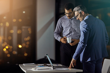 Image showing Businessman, colleagues and laptop at office in night for strategy, goals and target for investment in stock market. Stock broker team, reading and computer with innovation, working late and focus