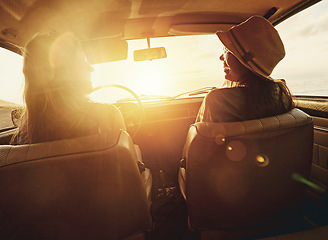 Image showing Woman, friends and road trip for sunset travel, summer vacation or holiday relaxing in the car together. Happy women enjoying traveling journey, sunshine or driving freedom with lens flare by a beach