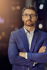 Image showing Confident, arms crossed and night with portrait of businessman in office for management, leadership and vision. Professional, executive and future with face of ceo focus on mindset, career or goals