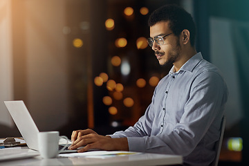 Image showing Businessman, laptop and working at night in office for planning strategy, overtime research and big data report deadline. Corporate male, late and thinking with digital tech device for iot web design