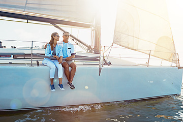 Image showing Yacht, relax and travel with a mature couple sitting on a boat out at sea for love, romance or dating together. Water, summer and ship with a man and woman enjoying a trip on the ocean while bonding