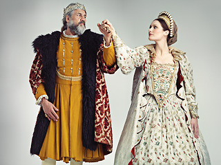 Image showing Medieval, love and king with queen in studio on gray background for power, ruler and leadership. History, theatre and isolated royal couple holding hands in vintage, renaissance and Victorian cosplay