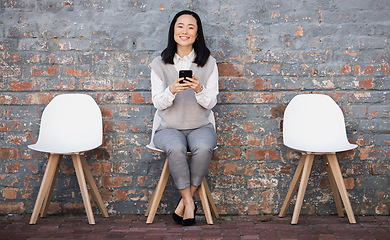 Image showing Woman waiting for interview on chair with phone, recruitment and employment with smile. Portrait of happy person in Japan sitting on chair, smiling and excited for job opportunity for Japanese people