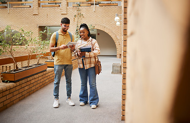 Image showing Students, university and education, tablet and books for learning, scholarship and collaboration on campus. College with man and black woman study together, learn with diversity and academic goals