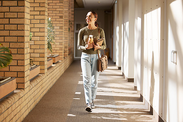 Image showing Woman, student and university hallway with a person walking ready for learning and study. Smile, college and back to school happiness of a female tutor on campus going to class happy and alone