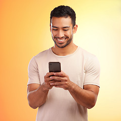 Image showing Man, studio and phone for social media, chat and online dating with smile, reading and happiness. Model, smartphone communication and texting app on social network ui and digital contact on internet