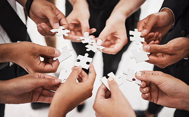 Image showing Hands, puzzle and business people collaboration, teamwork and integration closeup for planning. Team, hand and synergy with problem solving, partnership and people connecting to support innovation