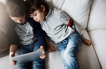 Image showing Top view, children or tablet for movie streaming, social media, or esports gaming on family home sofa. Curious kids, brothers or boys on digital technology for education app, learning support or help