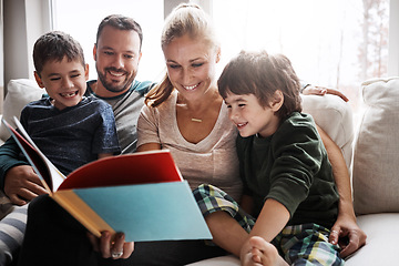 Image showing Mom, dad and kids reading book on sofa, storytelling time in living room of happy family home. Love, learning to read and couple with children, book and fantasy story on couch together on weekend.