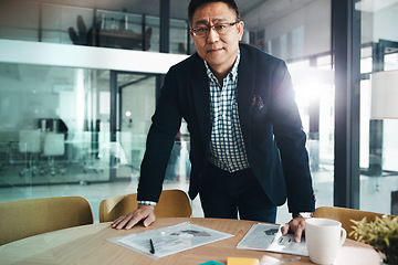 Image showing Professional, corporate and portrait of a mature businessman working on data in an office. Start, success and Asian employee with paperwork, documents and finance notes for accounting at an agency