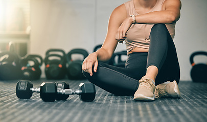 Image showing Dumbbells, gym and woman on a health studio club floor ready for training and exercise. Strength challenge, healthy athlete and power workout of an athlete on the ground rest after lifting weights