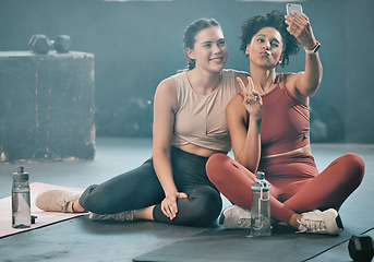 Image showing Woman, friends and fitness with phone for selfie, peace sign and pout after workout, exercise or training at gym. Sporty women with smile looking at smartphone for photo or healthy wellness together